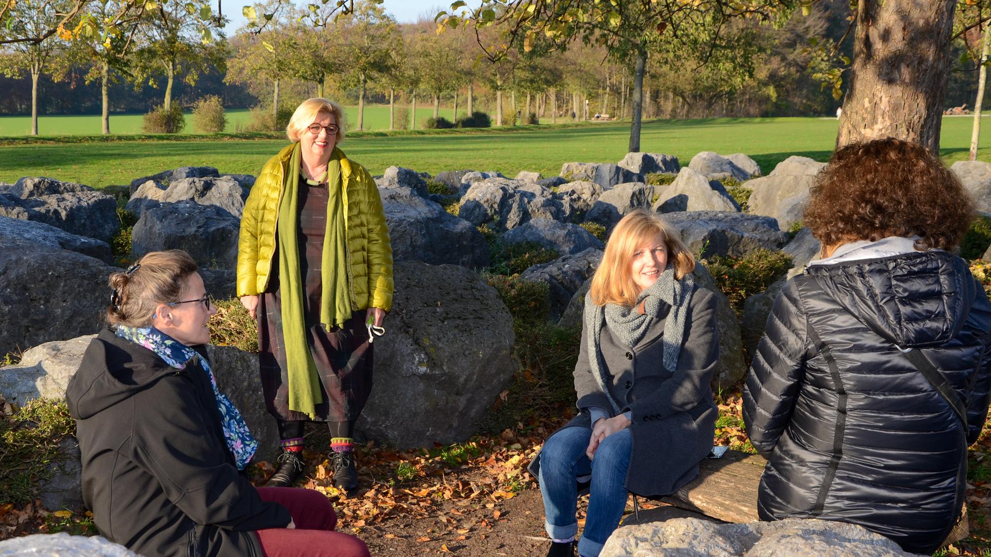 Susanne Kiepke-Ziemes (stehend) und Doris Zingsheim (2. v. r.) leiten das Trauercafé des Caritasverbandes. Den Trauernden Gabriele Unger (l.) und Maria H. (r.) hat die Unterstützung sehr geholfen. Das Foto entstand im Viersener Labyrinth – hier fand vor zehn Jahren die erste Aktion des Trauercafés statt. (c) Caritas