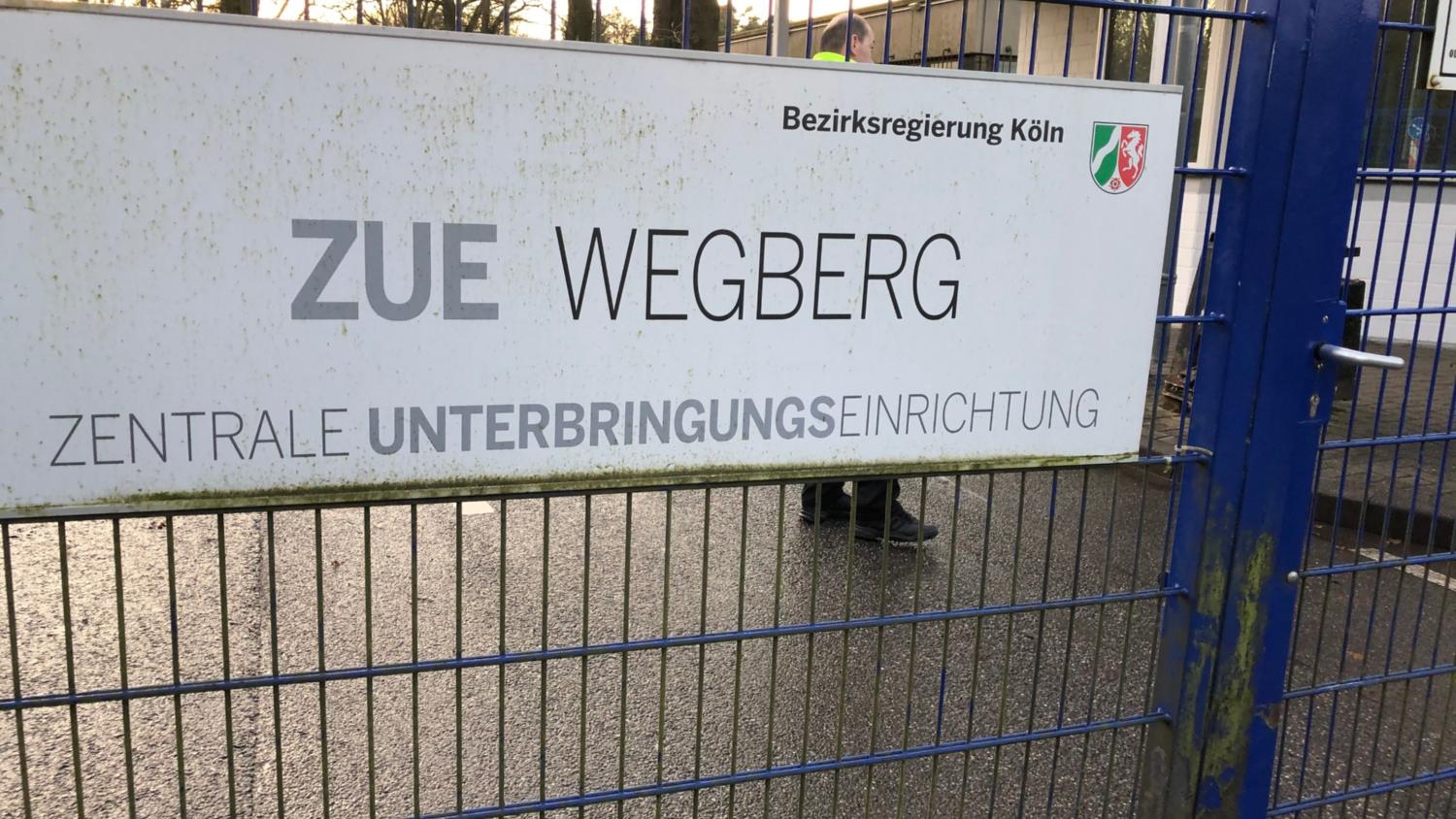 Die Zugänge zu den Zentralen Unterbringungseinrichtungen, wie hier in  Wegberg-Petersholz, sind von Gittertoren versperrt und von  Sicherheitsdiensten bewacht. (c) Garnet Manecke